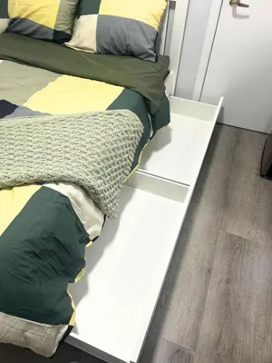 a bedroom with a bed on a white platform at Cozy Private Room Near Downtown Toronto in Toronto