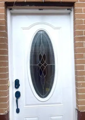 a white door with a stained glass window on it at Modern & Cozy Basement Suite Lower Unit - 3 rooms -1 King bed - 2 Car Parking in Pickering