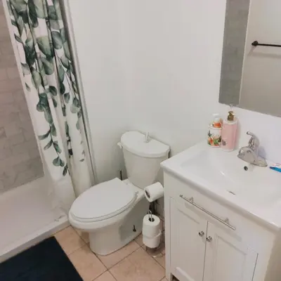 a white bathroom with a toilet and a sink at TORONTO BLUE JAYS- World Cup Stay in Toronto