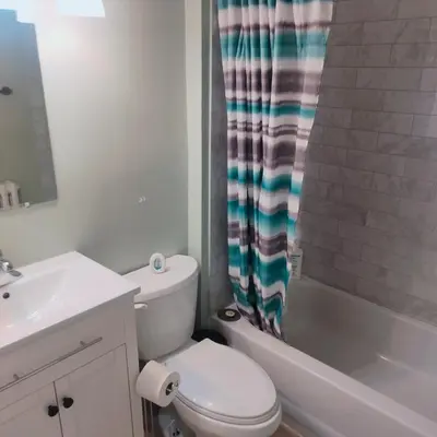 a white bathroom with a toilet and a sink at TORONTO BLUE JAYS- World Cup Stay in Toronto