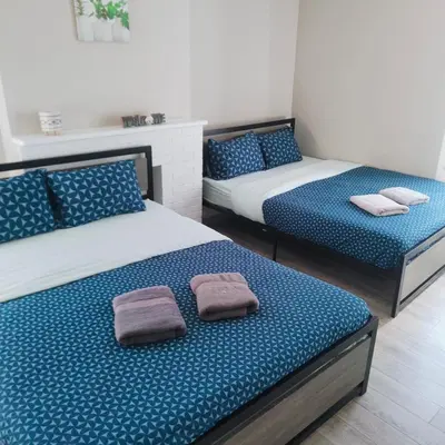 two beds in a room with towels on them at TORONTO BLUE JAYS- World Cup Stay in Toronto