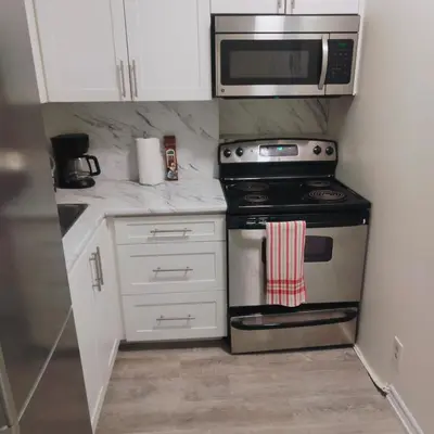 a kitchen with a stove and a microwave at TORONTO BLUE JAYS- World Cup Stay in Toronto