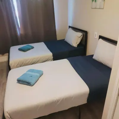 two beds in a hotel room with towels on them at TORONTO BLUE JAYS- World Cup Stay in Toronto