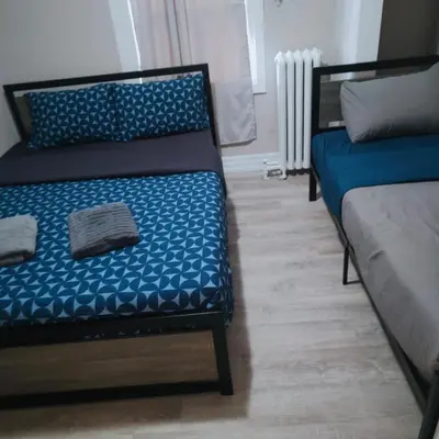 a bedroom with two beds with blue sheets at TORONTO BLUE JAYS- World Cup Stay in Toronto