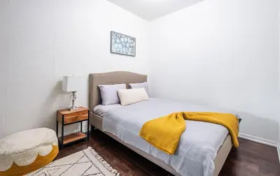a bedroom with a bed with a yellow blanket on it at 1 Bedroom plus Den Condo Garden View Fort York Downtown Toronto in Toronto