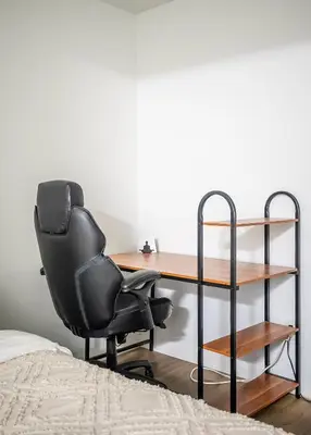 a black office chair sitting next to a desk at 1 Bedroom plus Den Condo Garden View Fort York Downtown Toronto in Toronto