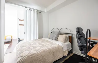 a bedroom with a bed and a desk and a chair at 1 Bedroom plus Den Condo Garden View Fort York Downtown Toronto in Toronto