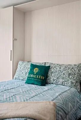 a green pillow sitting on top of a bed at Modern Studio Condo Yonge Street Downtown Toronto in Toronto