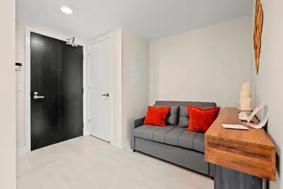 a living room with a couch and a table at Panoramic 2 Bedroom plus Den Condo Yonge Street Downtown Toronto in Toronto