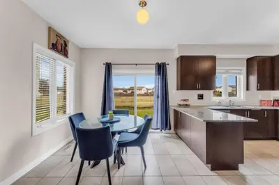 a kitchen and dining room with a table and chairs at Luxury Home Mins from Waterfall next to Transit in Niagara Falls