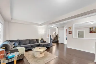 a living room with a couch and a table at Luxury Home Mins from Waterfall next to Transit in Niagara Falls
