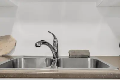 a sink with a faucet on a kitchen counter at 5 Mins to the Falls Brand New Home in Niagara Falls