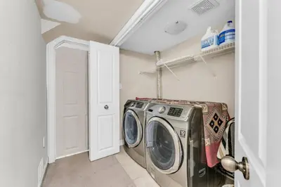 a laundry room with a washing machine in it at Charming Home with Airport and Toronto Nearby in Brampton