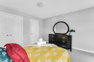 a bedroom with a bed with a mirror and a dresser at Cozy Home in Niagara 10 mins from Falls and Brock in Thorold