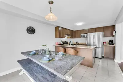 a kitchen with a table with dishes on it at Cozy Home in Niagara 10 mins from Falls and Brock in Thorold