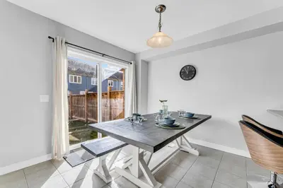 a dining room with a table and a window at Cozy Home in Niagara 10 mins from Falls and Brock in Thorold
