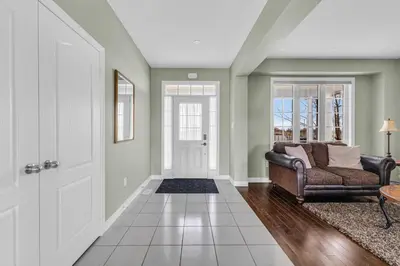 a living room with a couch and a door at Luxury Mansion with Chefs Kitchen by Niagara Falls in Thorold