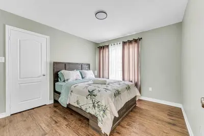 a bedroom with a bed and a window at Luxury Mansion with Chefs Kitchen by Niagara Falls in Thorold