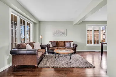 a living room with two couches and a coffee table at Luxury Mansion with Chefs Kitchen by Niagara Falls in Thorold