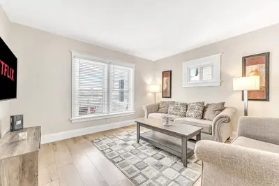 a living room with a couch and a table at Pristine Home 5 min walk to Clifton Hill in Niagara Falls