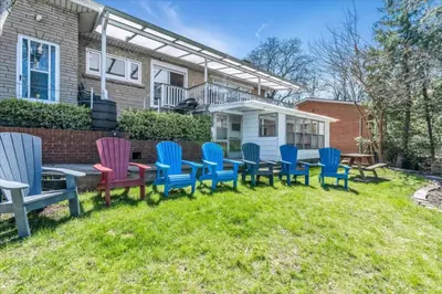 a group of colorful chairs in the yard of a house at War of 1812 Battlefield Home by Falls in Niagara Falls