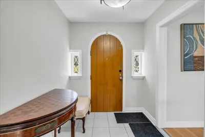 a hallway with a wooden door in a house at War of 1812 Battlefield Home by Falls in Niagara Falls