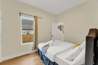 a bedroom with a bed and a window at Sunshine Villa Closest BNB to Falls Hot Tub Oasis in Niagara Falls