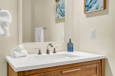 a bathroom with a white sink and a mirror at Sunshine Villa Closest BNB to Falls Hot Tub Oasis in Niagara Falls