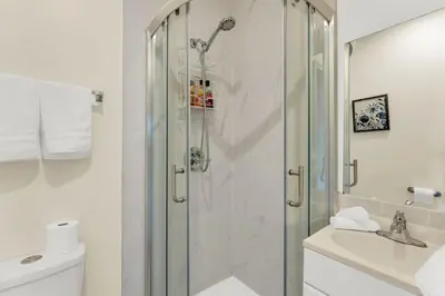 a shower with a glass door in a bathroom at Sunshine Villa Closest BNB to Falls Hot Tub Oasis in Niagara Falls