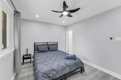 a bedroom with a bed and a ceiling fan at Spacious 6BR Getaway Sleeps 16 Yard and Parking in Brampton
