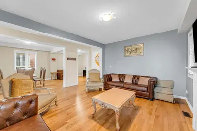 a living room with leather furniture and a table at Bright and Stylish Family Home Near Niagara Falls in Thorold