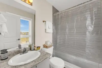 a bathroom with a sink and a toilet and a shower at Stylish Niagara Falls Getaway with Rooftop City Views in Niagara Falls