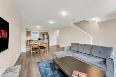 a living room with a couch and a table at Stylish Niagara Falls Getaway with Rooftop City Views in Niagara Falls