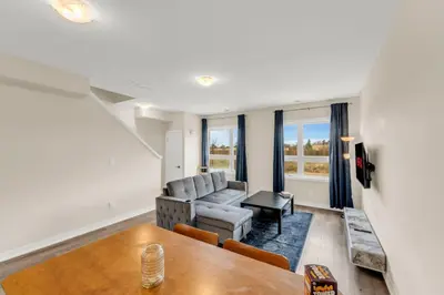 a living room with a couch and a table at Stylish Niagara Falls Getaway with Rooftop City Views in Niagara Falls