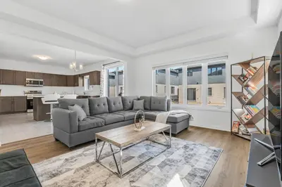 a living room with a couch and a table at Luxury New Home By Niagara Fall in Fonthill