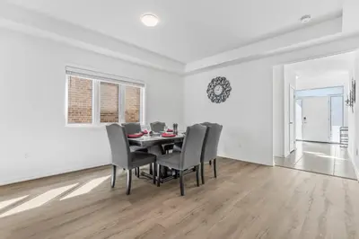a white dining room with a table and chairs at Luxury New Home By Niagara Fall in Fonthill