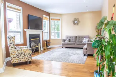a living room with a couch and a fireplace at Royal Luxury Central Home with Gazebo By Toronto in Brampton