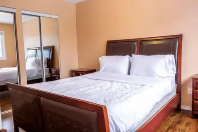 a bedroom with a large bed with white sheets and pillows at Royal Luxury Central Home with Gazebo By Toronto in Brampton