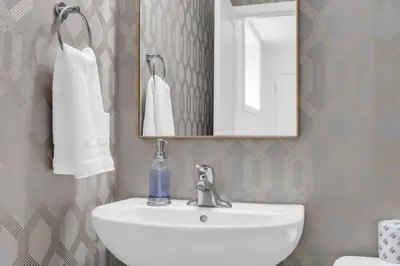 a bathroom with a white sink and a mirror at New 2BD Townhouse Mins from Niagara Falls in Niagara Falls