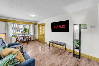 a living room with a couch and a table at Cozy Home Short Walk to Falls Nintendo FirePit in Niagara Falls
