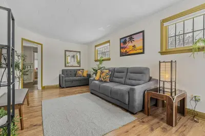 a living room with a couch and a table at Cozy Home Short Walk to Falls Nintendo FirePit in Niagara Falls