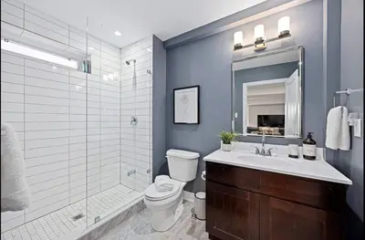 a bathroom with a toilet and a sink and a shower at Casa Hotel Stylish Modern Family Suite with Patio in Toronto
