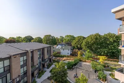 an apartment balcony with a garden and buildings at Scarborough Oasis near UofT campus, Free Parking in Toronto