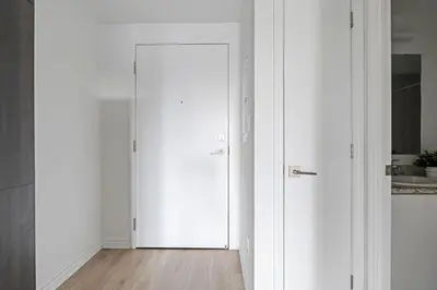 a hallway with white doors and a wooden floor at Scarborough Oasis near UofT campus, Free Parking in Toronto