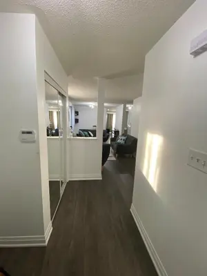 an empty living room with a couch and a living room at The cozy crest in Brampton
