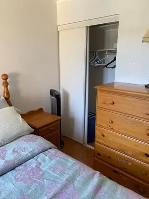 a bedroom with a bed and a dresser and a closet at The cozy crest in Brampton