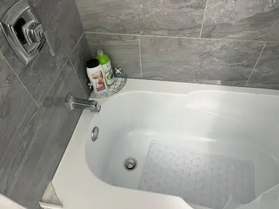 a white bath tub in a bathroom at The cozy crest in Brampton