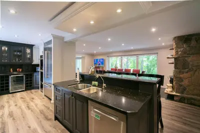 a kitchen with a sink and a counter top at Luxury 4BR Stay with Swim Spa, Golf and Fireplaces in Caledon