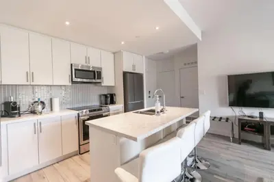 a kitchen with white cabinets and a counter top at Modern 2BR Getaway with Balcony, BBQ and Parking in Innisfil