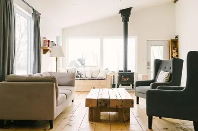 a living room with two couches and a fireplace at Wellington Waterfront Home in Wellington
